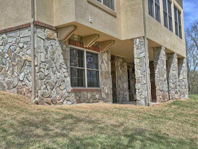 Downspouts, kick-out flashing, overhangs, and a site graded to direct water away from the structure are among the high-performance site water management details.