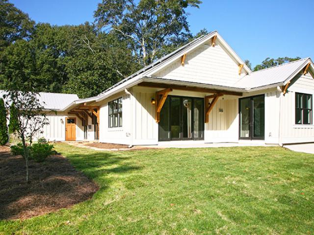 The home's white metal roof reflects sunlight, reducing solar heat gains through the roof in this hot-humid location.