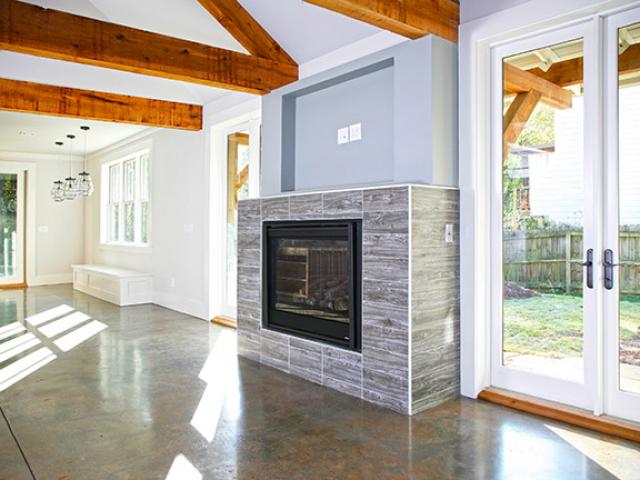 The home's stained concrete flooring takes advantage of passive solar heating, absorbing heat from the sun during the day and releasing it into the home at night.