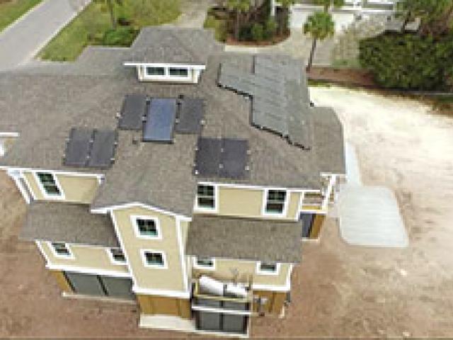 Solar thermal panels on the home's east- and south-facing roof slopes provide most of the heat for the home's two 40-gallon hot water storage tanks. Solar electric panels installed on the roof have a production capacity of 6.0 kW. Although tied to the grid, they also keep a battery charged to provide power to critical needs in case of a power outage.