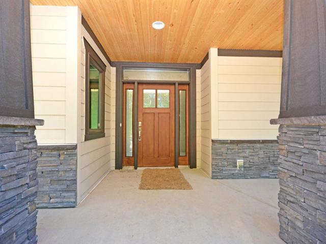 Covered porches and deep overhangs provide protection from summer heat gain and winter storms for this cold-climate home.