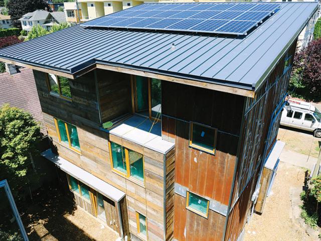Durable standing-seam metal roofing covers the shed roof, which has very few penetrations to minimize heat loss and maximize the space available for solar photovoltaic panels. Dwell installed 8.1 kW of PV, which will help cut energy costs to $51 per year.