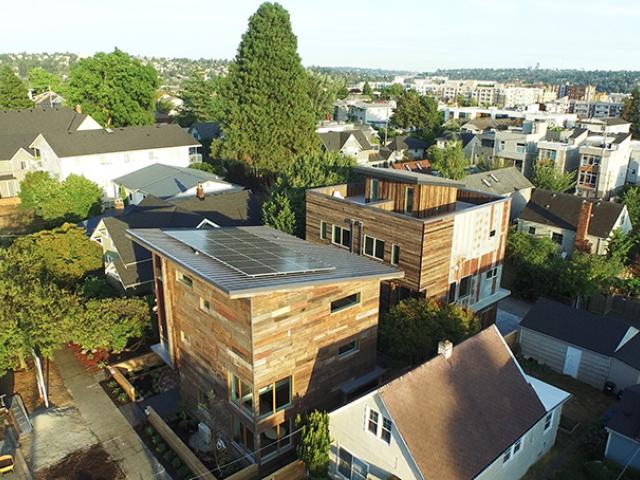 Dwell maximized use of space on the urban infill lot by splitting the parcel and constructing a net zero duplex behind the award-winning home.