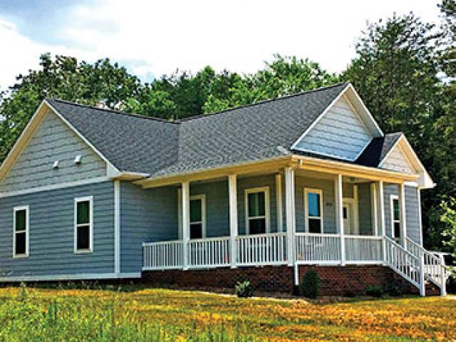 Engineered wood siding and 30-year architectural shingles installed over a coated OSB roof decking provide a durable finish to the efficient home.
