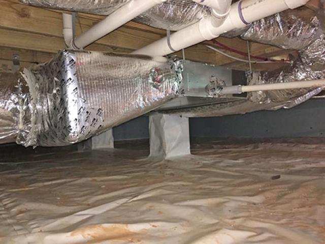 The insulated crawlspace is a temperate location for the ducted mini-split heat pump, which heats and cools the home with a heating efficiency of 10 HSPF and a cooling efficiency of 18 SEER.