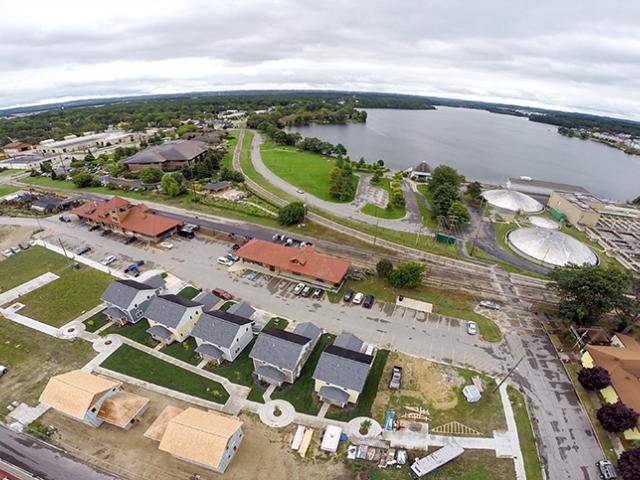The houses are oriented to a central garden with south-facing roofs optimized for solar energy production.