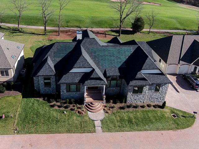 The solar electric panels on this home look similar to traditional roof shingles but provide 7 kW of solar power. They are projected to boost the annual energy savings to $2,500 per year and $109,000 over a 30-year mortgage.