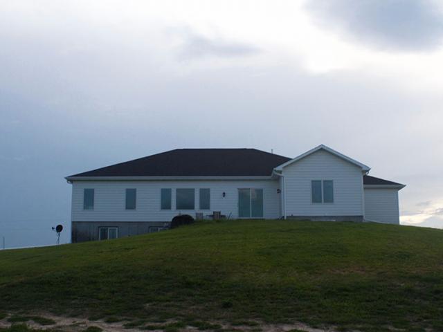 The site has the advantage of a southern exposure for future solar panels. The slope allowed for the construction of a daylight basement providing living space without increasing the building footprint.