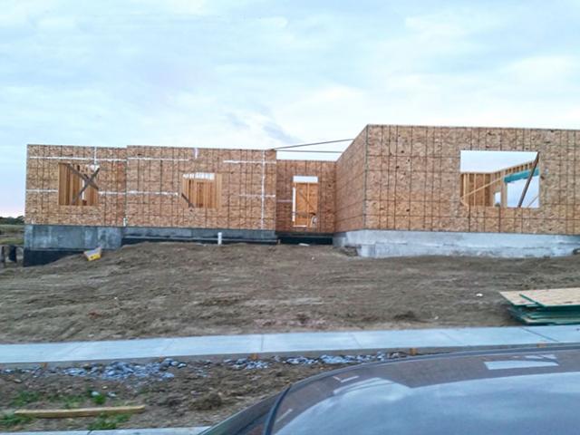 Although the site already had sandy soil and considerable slope, Knaggs Construction took steps to protect the foundation from moisture including laying 6 inches of packed gravel before pouring the concrete slab, using perforated plastic footing forms that stay in place after the concrete footings are poured to provide foundation drainage, damp-proofing the basement walls, and installing drains in all of the window wells.