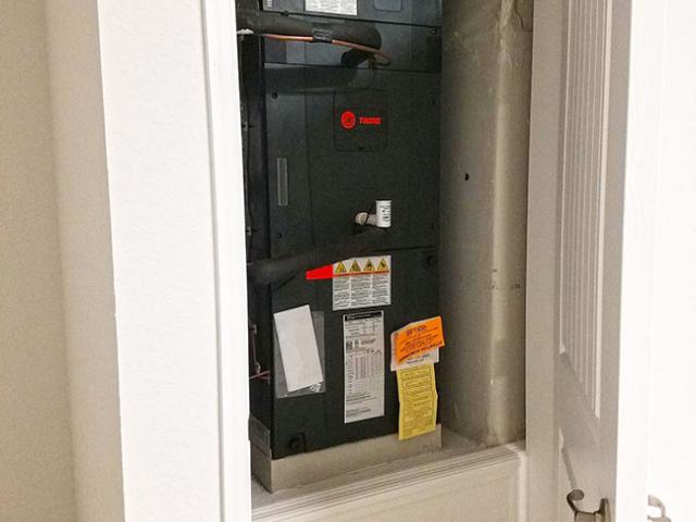 A high-efficiency heat pump heats and cools the home.