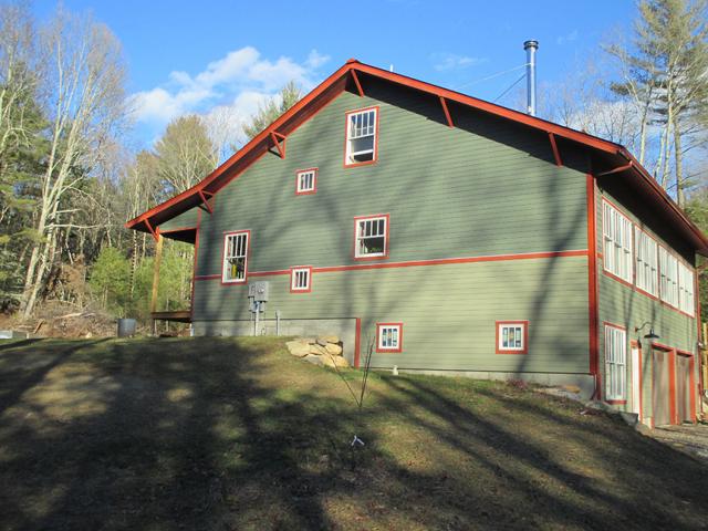 Taking advantage of a sloping lot, the builder constructed a daylight basement that provides living space and garages without increasing the home's footprint.