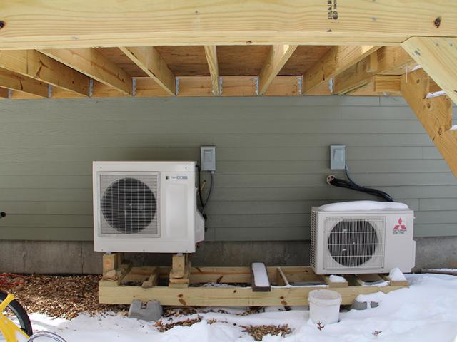 An ultra-efficient air-to-water heat pump provides hot water for radiant in-floor heating and for domestic hot water. A highly efficient (SEER 26) ductless heat pump provides supplemental cooling as needed.