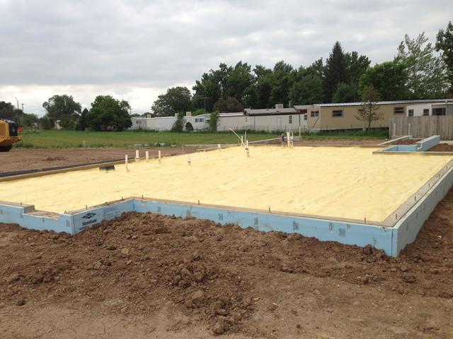 Rigid foam wraps the exterior of the foundation slab in R-10 of thermal protection.