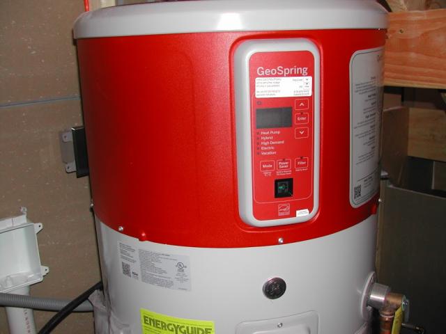 A heat-pump water heater supplies the bathrooms while an electric on-demand water heater produces endless hot water instantly at the kitchen sink.