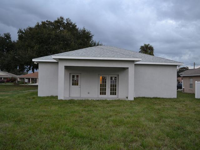 The hip roof design adds hurricane resistance; the roofing is reflective ENERGY STAR-rated shingles that minimize solar heat gain in the attic.