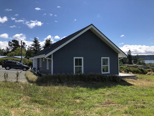 Durable fiber cement siding covers the walls of the airtight structure, which is constructed with 6.5-inch graphite-enhanced structural insulated panels (SIPs) and 10.25-inch SIP roof panels. The SIP panels were triple-sealed with spray foam, tape, and mastic, then the walls were wrapped in a highly tear-resistant house wrap that was also taped at the seams, providing even more air barrier protection.