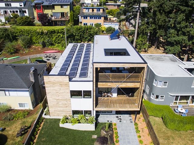 Rows of solar panels line the roof of the west Seattle home helping to bring the already energy-efficient home’s HERS score from a low 35 down to net zero.