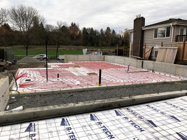 The home is heated with in-floor hydronic radiant heating tubes that were installed in the R-20 insulated slab. The hot water is provided by an air-to-water heat pump with an efficiency of COP 3.92.