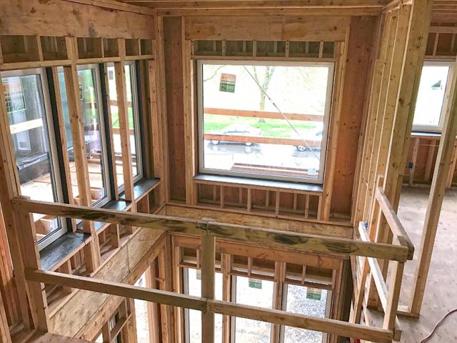 The highly efficient wall system consists of two sets of stud walls set side by side to create a 12-inch-thick double-stud wall cavity that is filled with a continuous blanket of R-44 dense-packed cellulose insulation.