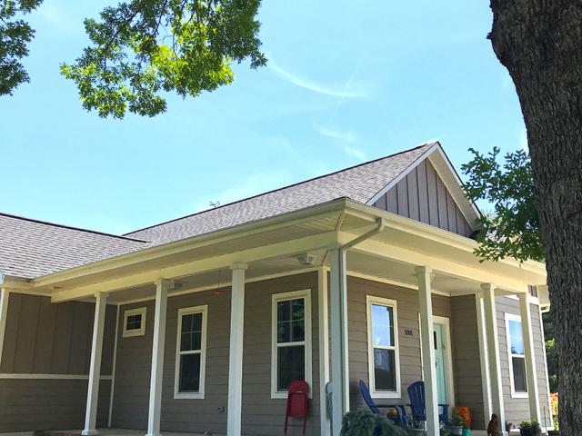 Deep porches protect windows from rain and overhead sun and provide a naturally cooled place to gather in mild weather.