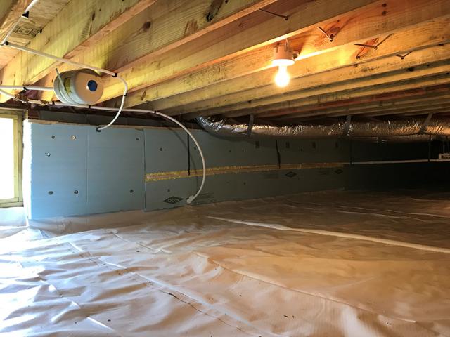 The crawlspace was sealed and insulated along the inside with R-10 of rigid EPS foam, while an extra-thick layer of visqueen serves as a vapor barrier over the crawlspace floor.