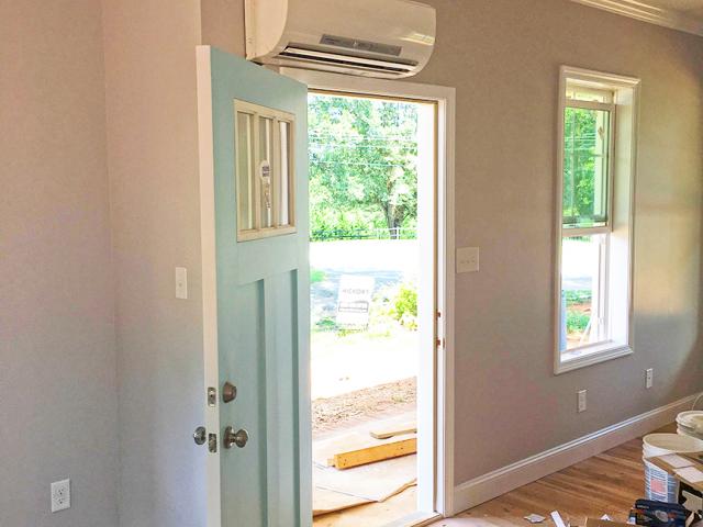 A single mini-split ductless heat pump was installed on the wall above the front door to provide heating and cooling to the home with a very high efficiency of 23 SEER and 11 HSPF.