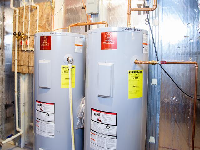 Hot water is provided by a 55-gallon desuperheater fed from the geothermal heat pump and a 55-gallon, .91 EF electric water heater. A push button-activated recirculating pump brings hot water to the faucets with no water waste.