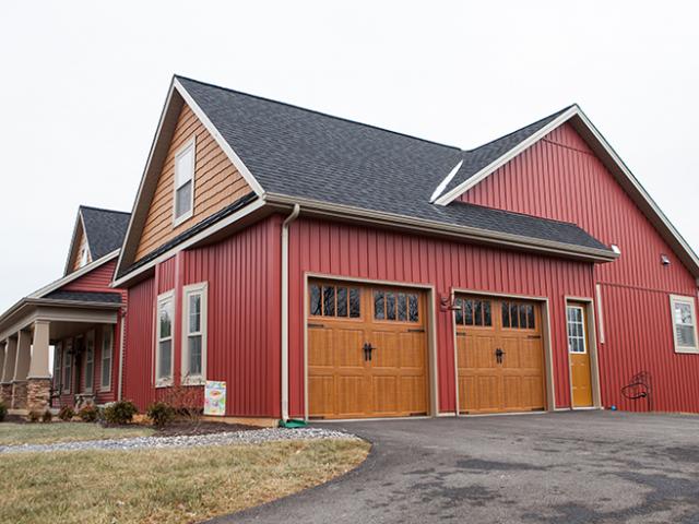 Lifetime warrantied shingles, 15-pound felt, ice-and-water shield, kick-out flashing, and 5-inch sidewall flashing protect the vented attic, which is insulated at the attic floor with 1 inch of closed-cell foam sprayed directly onto the drywall then covered with R-49 of blown fiberglass for an overall insulation value of R-56.