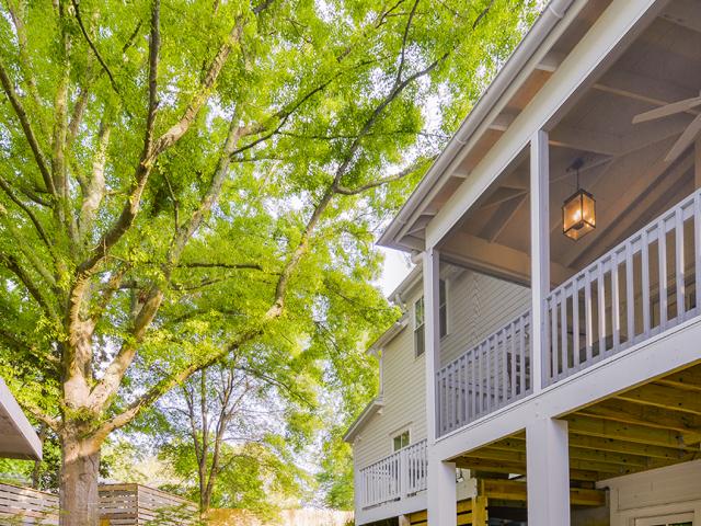Durable fiber cement siding covers the walls and 29-gauge ENERGY STAR-rated coated-metal roofing covers the roof of the farmhouse style home. The metal roofing sits on furring strips over 15-pound felt over coated and taped OSB roof sheathing over the unvented attic, which is insulated on the underside with R-21 of open-cell spray foam.