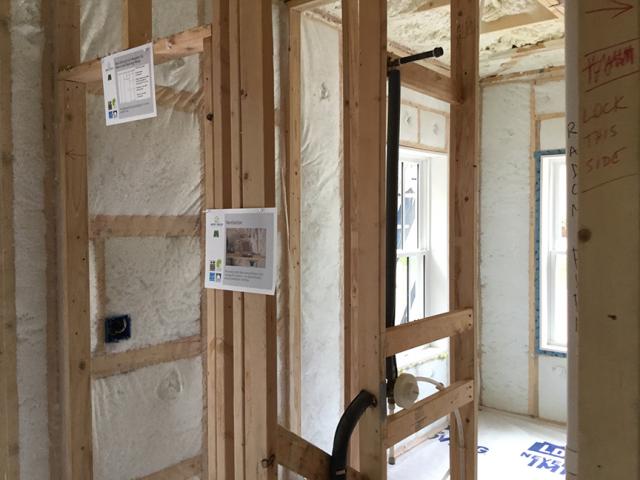 The 2-by-6, 24-inch on-center walls were constructed with several advanced-framing techniques like California corners, limited framing at windows and doors, ladder blocking at interior-exterior wall intersections, and no headers over windows and doors on non-load bearing walls. The exterior walls were filled with R-23 of blown fiberglass.