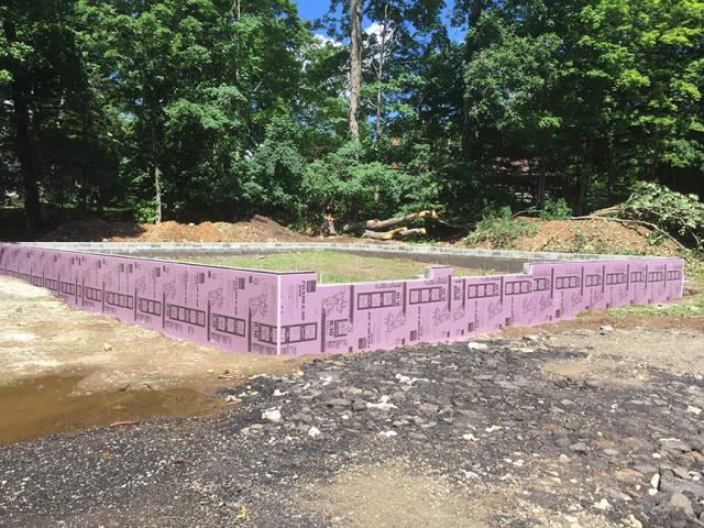 The concrete block foundation wall is insulated on the exterior with 2 inches of rigid XPS foam.