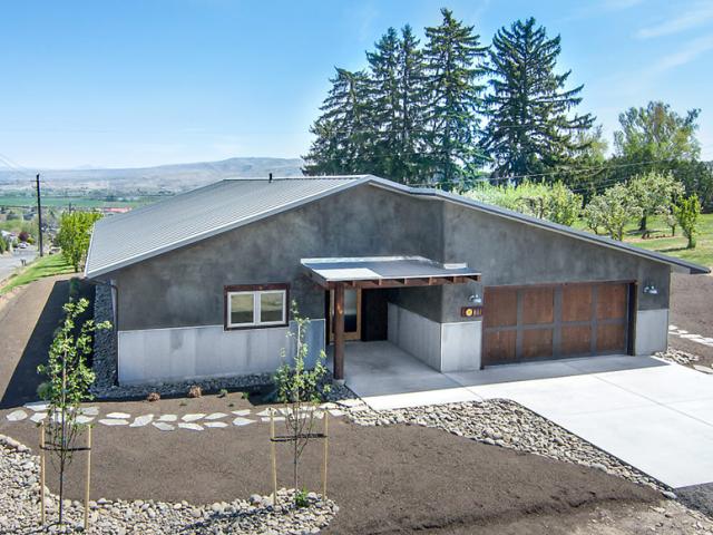 The home's snap-lock metal roofing helps reflect heat away from the unvented attic. Reclaimed metal roofing and reclaimed wood add a rustic touch to the walls, windows, and doors. The remaining siding is natural hydraulic lime, which produces a finish similar to cement.