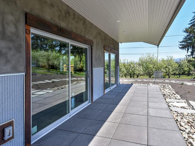Deep overhangs and porches shade windows and walls from the intense summer sun of eastern Washington.