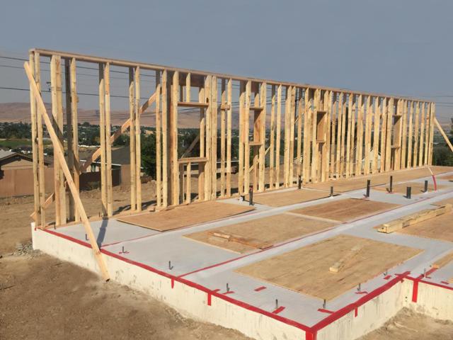 The home's exterior walls consist of two 2-by-4, 24-inch on-center framed walls set next to each other to form an 11-inch wall cavity that is sheathed with 1/2-inch plywood.