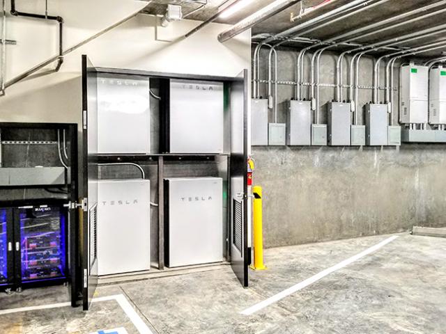 An extensive battery storage system saves solar-generated power for use during evening peak hours.