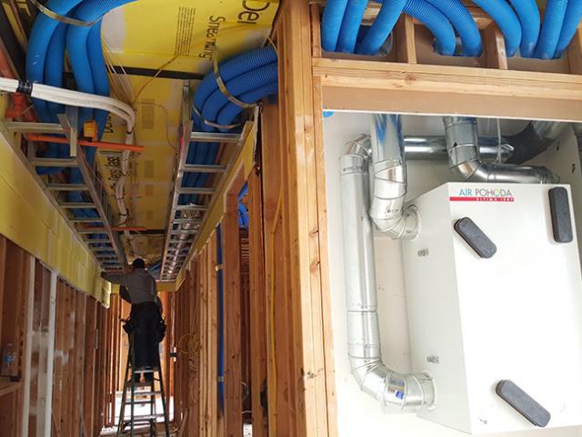 A triple-filtered energy recovery ventilator provides ducted fresh air throughout the homes.