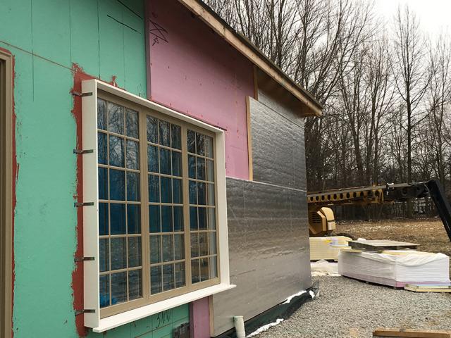 Exterior walls were sheathed with a coated OSB with an adhered rigid foam that was taped at the seams and covered with a paint-on air barrier. The pool building has a double-layer of rigid foam.