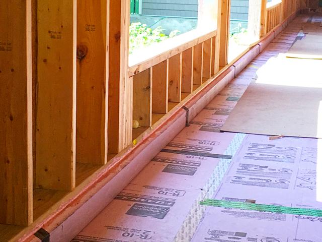Rigid foam insulation was installed under all of the slabs. To keep moisture from seeping up into the foundation wall, the entire footer was encapsulated in a liquid-applied capillary break membrane prior to setting the foundation wall concrete forms. The foundation walls were also covered with a liquid-applied waterproofing membrane that was topped with R-10 of EPS.