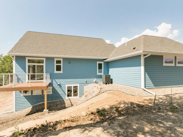 A combination of 2 inches of closed-cell spray foam plus blown fiberglass provides an R-60 layer of insulation over the ceiling deck, while light-colored asphalt shingles and ridge vents help prevent heat build-up in the vented attic.