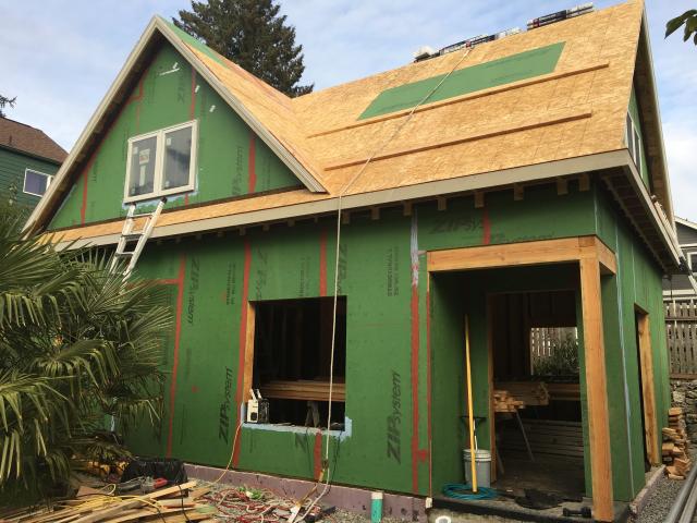 The coated OSB sheathing is sealed at the seams with a paint-on flashing to provide a seamless weather-resistant barrier over the walls. A paint-on flashing seals and protects the window sills.