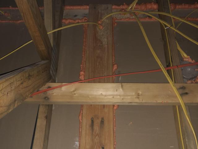 From the attic, the ceiling deck below is thoroughly air-sealed by caulking drywall to framing and caulking around wiring and light fixture holes.