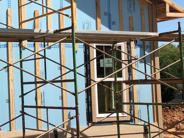 Rigid foam provides a continuous blanket of thermal protection around the home. All seams are taped to keep out air and moisture then 1-by-4 furring strips are installed to provide a ventilation and drainage gap behind the engineered wood lap siding.