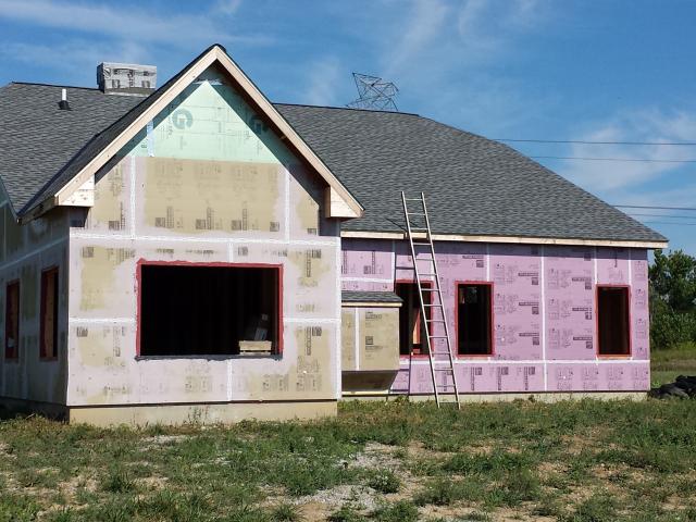The walls were wrapped in a continuous blanket of 2-inch-thick rigid foam insulation.