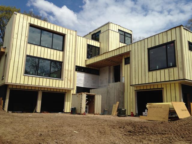 The walls of the home are wrapped on the exterior with plywood sheathing, house wrap, and 2 inches of rigid foam, then a 3/8-inch drainage gap behind the fiber cement siding.