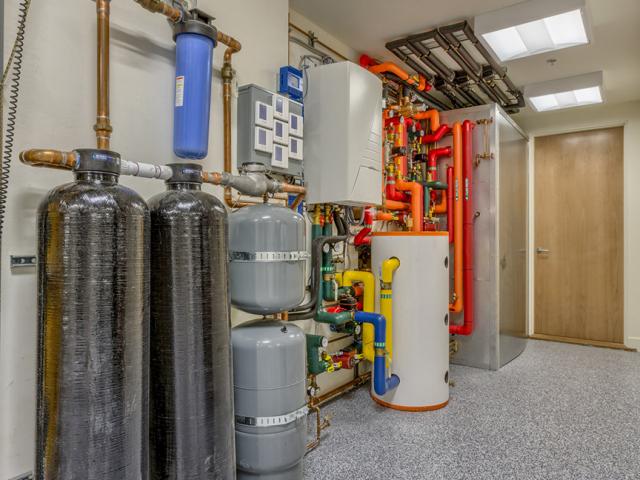 In addition to solar water heating, the home is equipped with a fan coil supplied by an air-to-water heat pump and a ducted mini-split heat pump that provides backup heating and cooling. A heat pump water heater provides additional backup hot water.