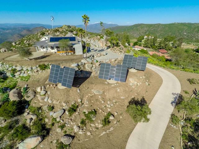 In a quest for energy and water self-sufficiency, the homeowners installed 22 kW of sun-tracking photovoltaic panels, a 3.2-kW wind mill, batteries for power storage, a solar thermal water heating system, and nine 10,000-gallon tanks as part of a water collection and recycling system that meets all of the home's domestic water, irrigation, and fire suppression needs.