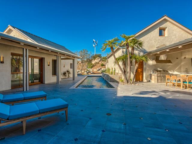 The solar-reflectant metal roof and low-emissivity triple-pane windows block unwanted solar gain while the home's U-shaped design and deep overhangs provide shade.