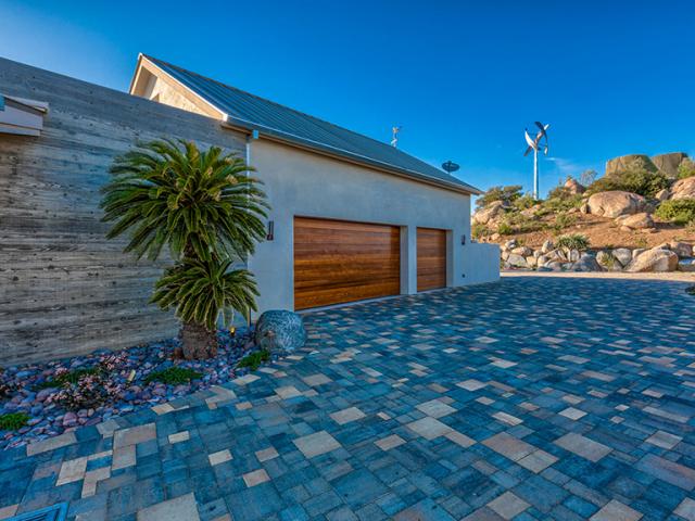 Stone, gravel, and pavers provide a pervious, fire-resistant ground cover around the home while xeriscaping keeps irrigation needs at a minimum. Behind the home's three-coat stucco siding, a liquid-applied membrane provides a weather-resistant barrier and rain screen.