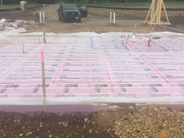 The home's slab-on-grade foundation is wrapped in a blanket of rigid foam extending completely under the slab and along the edges.