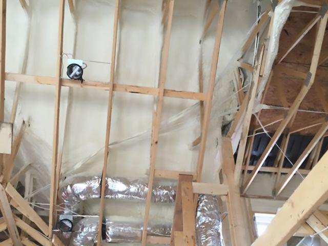 Closed-cell spray foam fills the rafter bays of the home's vaulted ceilings and provides a 2-inch layer of air sealing and insulating protection under 12 inches of blown cellulose on the flat-ceilinged portions of the home.